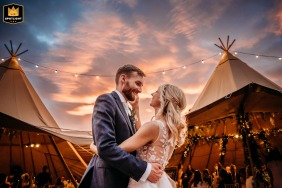 In their Cavan home garden, Ireland, the couple embrace, silhouetted against a breathtaking sunset.
